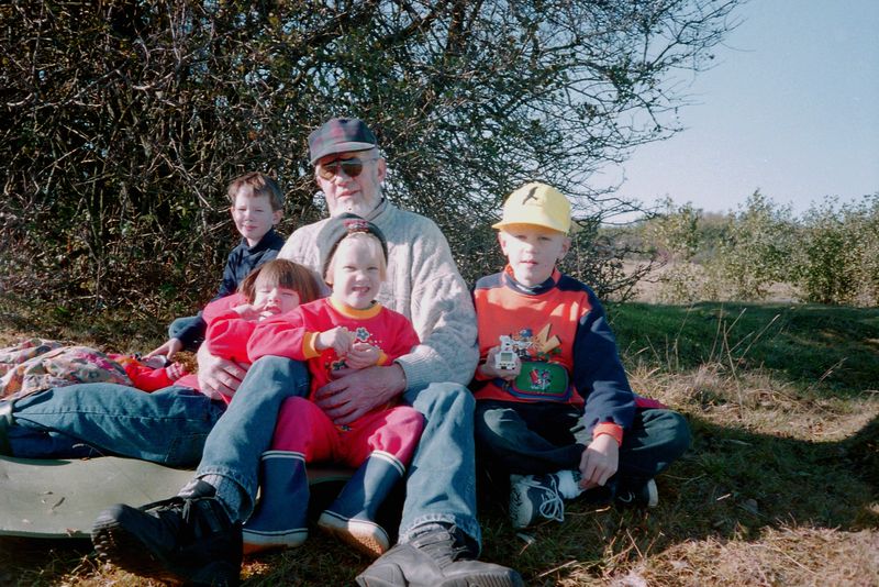  Min far Helge omgiven av sina barnbarn. Från vänster:min brors barn Alexander, f-90, Josefin f-93, sedan tcå av mina egna Maria f-92 och Erik f-90. Oskar f-97 bär jag själv i sele på magen denna härliga höstdag